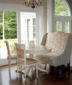 a dining room table with chairs and a chandelier