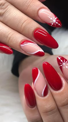 a woman's nails with red and white designs on them