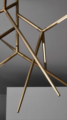 a gold colored metal structure hanging from the ceiling