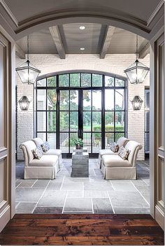 a living room filled with furniture and windows