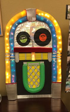 an old school juke machine is decorated with lights