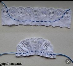 two pieces of white lace with blue thread