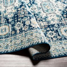 a blue and white rug on the floor