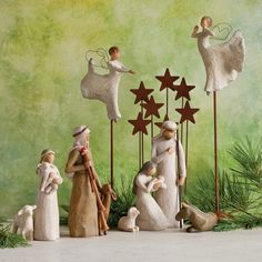 a group of figurines that are standing in front of a green background with stars