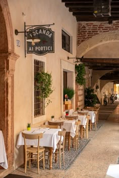 an empty restaurant with tables and chairs lined up against the building's exterior wall