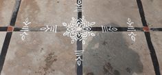 an artistic tile design on the ground with white and black lines painted on it's sides