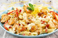 a plate of pasta with shrimp and tomato sauce