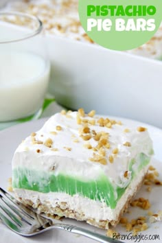 a white plate topped with a piece of cake next to a glass of milk and a fork