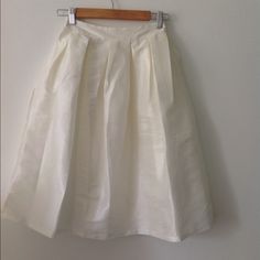 Knee Length Pleated White (Tint Of Ivory) A Line Skirt. Never Worn With Tag (Nwt) The Back Of The Skirt Is Elastic/Stretchy. Perfect For Work Or Baby Shower. Feminine Full Cream Skirt, Elegant White Skirt For Brunch, Spring Cream Lined Skirt, Cream Skirt For Summer Brunch, White Cotton Wedding Skirt, White Pleated Skirt For Wedding, Elegant Cream Skirt For Summer, Chic Cream Skirt For Brunch, Elegant Cream Summer Skirt