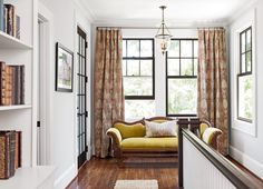 a living room filled with furniture and lots of windows