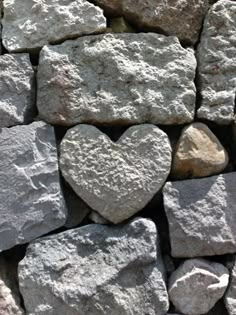 a pile of rocks with a heart shaped rock in the middle on it's side