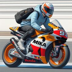 a man riding on the back of a motorcycle down a race track