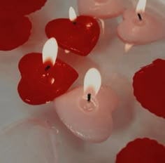 several candles with red hearts on them