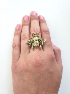 "This beautiful adjustable bee ring is perfect for a summer woodland look. Very pretty vintage inspired. Sweet as can bee! 24k antiqued gold plated brass bee attached to an adjustable ring. Highly detailed, rustic, woodland accessory perfect for any day. Ring adjusts from size 7 - 9 and a half. Bumble Bee measures 1.25\" wide x 1.25\" long. (34mm wide x 34mm long). Your order will be shipped in two business days. Every piece is handcrafted in my home jewelry studio and is one of a kind. All of m Bumble Bee Ring, Sweet As Can Bee, Gift Box For Men, Bee Ring, Jewelry Studio, Queen Bee, Queen Bees, Favorite Rings, Adjustable Ring