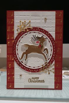 a close up of a card with a reindeer in the center and christmas decorations around it