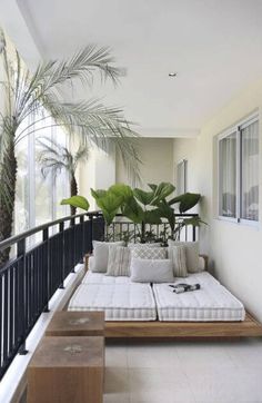 a couch sitting on top of a wooden floor next to a balcony