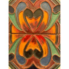 an art nouveau style tile with hearts and flowers on the top, in multicolored colors