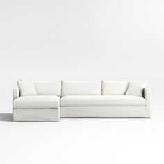 a white couch sitting on top of a white floor