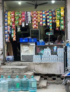 water bottles are on the ground in front of a store