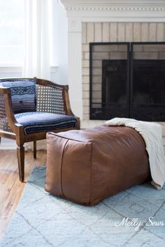 a leather pouf chair and ottoman in front of a fireplace with the words diy leather pouf on it