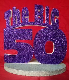 purple glitter 50th birthday cake topper with the number fifty