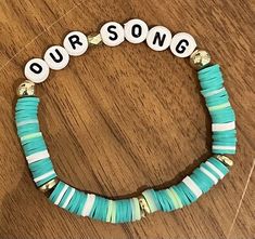 a cute, preppy, aesthetic 'our song' inspired taylor swift themed clay bead bracelet that is perfect for any taylor swift lover or any die hard swiftie to wear and make this beautiful DIY polymer charm bracelet as summer jewelry this wonderful season 🤪🦋🎀💗🥥🌺✨ Taylor Swift Clay Braclets, Clay Bead Ideas Taylor Swift, Taylor Swift Song Bracket All Songs, Taylor Swift Themed Clay Bead Bracelets, Bracelet Ideas Clay Beads Taylor Swift, T Swift Bracelet Ideas, Our Song Taylor Swift Bracelet