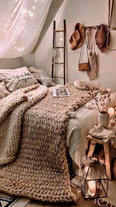 a bed in a room with lots of pillows and blankets