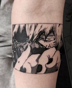 a person with a tattoo on their arm that has an image of anime characters in it