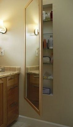 a bathroom with wooden cabinets and marble counter tops