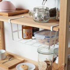 the shelves are filled with jars and containers for food, including cookies or other items