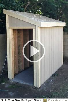 a small shed with the door open and it's inside being worked on by someone