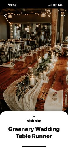 a long table with candles and flowers on it in front of a restaurant sign that says visit greenery wedding table runner