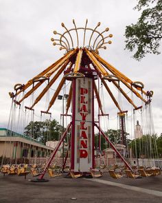 an amusement park ride with swings and seats