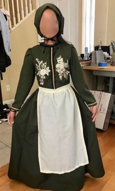 a mannequin wearing a green and white dress