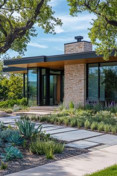 a modern home surrounded by trees and plants