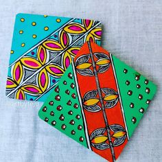 three brightly colored napkins with designs on them