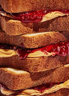 peanut butter and jelly sandwich stacked on top of each other with syrup flowing down the middle