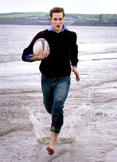 a man is running in the water with a ball