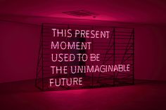 this present moment used to be the unimaginaable future neon sign in a dark room