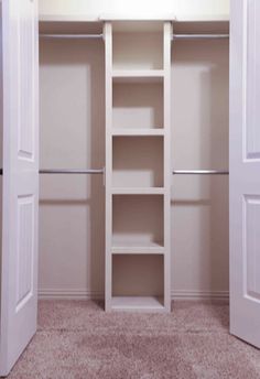 an empty closet with two doors open and shelves on the wall next to each other