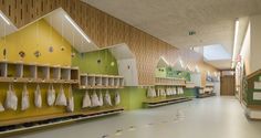 the inside of a children's playroom with lots of shelves and hanging items