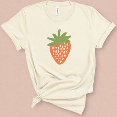 It wouldn't be summer without fresh juicy sweet strawberries! This minimal strawberry graphic tee is perfect for a summer BBQ, a morning at the local farmers market, or strawberry festival, oh and don't forget the strawberry lover. DETAILS This medium weight graphic t-shirt is super soft, comfy. It fits like a well loved favorite tee the first time you put it on, and is soon to become your go to tee. This durable crew neck, short sleeve shirt is made with superior combed and ring-spun cotton sur Summer Organic Cotton T-shirt, Organic Cotton Summer T-shirt, White T-shirt With Fruit Design For Spring, Organic Short Sleeve T-shirt For Spring, Sweet Summer Cotton Shirt, Sweet Cotton Summer Shirt, Fun Strawberry Print Crew Neck T-shirt, Organic Cotton T-shirt For Spring, Cute Summer Shirt With Strawberry Print