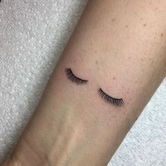 a woman's arm with eyelashes on it