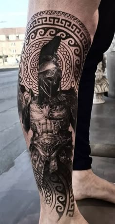 a man's leg with a tattoo on it and an image of a warrior