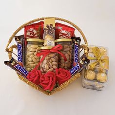 a basket filled with nuts and chocolates next to a package of candy candies