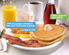 a breakfast plate with pancakes, bacon and eggs on it next to two glasses of orange juice