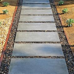 a walkway made out of concrete and gravel