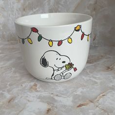 a white bowl with a snoopy christmas light on it