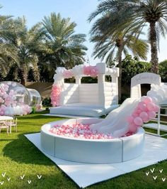 an inflatable pool with pink and white balloons