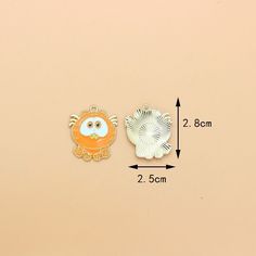 two different types of brooches are shown on a beige background, one is orange and the other is white